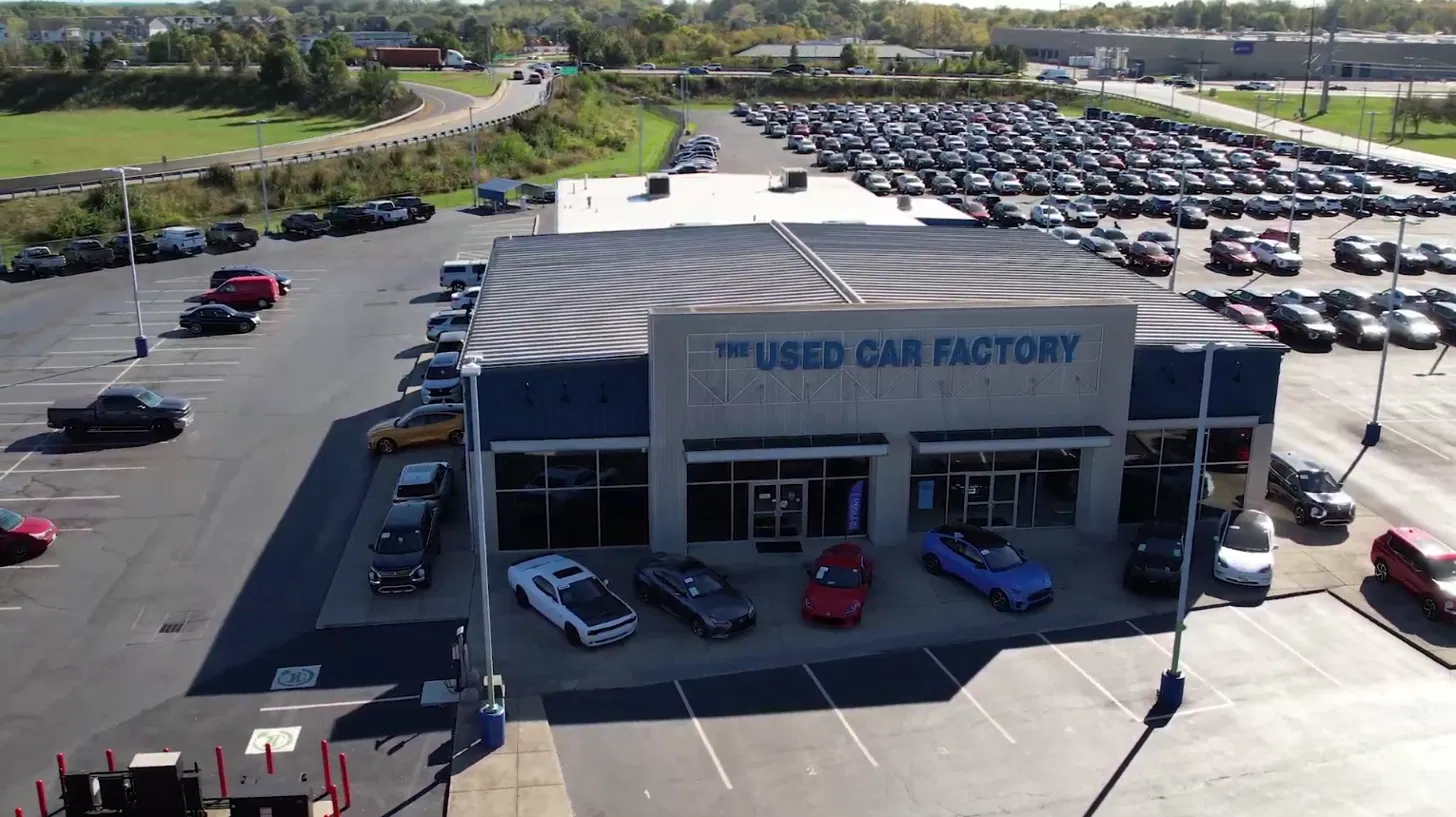 Certified used vehicles lined up outside the Ricart Used Car Factory showroom