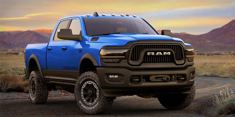 Blue RAM 2500 parked with mountains behind